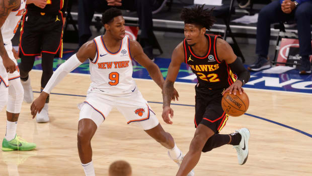 Hawks' Cam Reddish guarded by Knicks guard RJ Barrett.